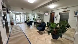 a lobby with furniture and a potted plant