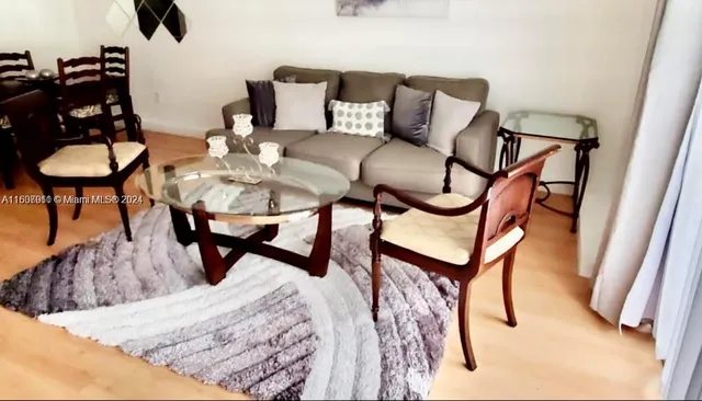 a living room with furniture and a rug