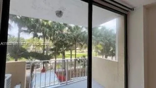 a view of a glass door with a yard from a balcony