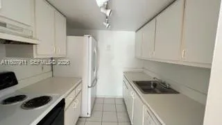 a kitchen with a sink a stove and refrigerator