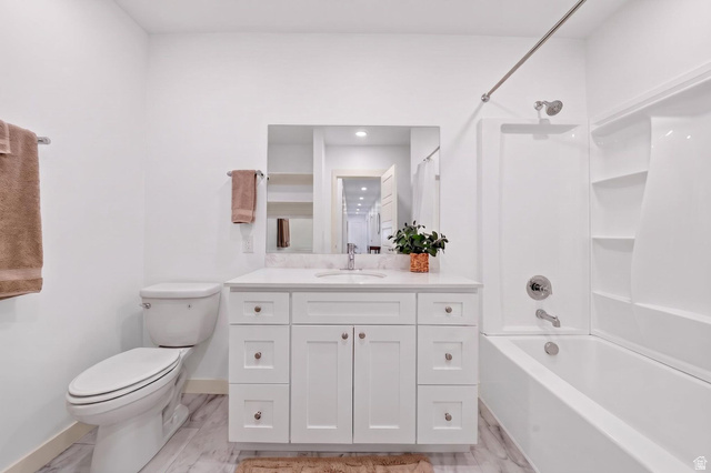 1165 West Union Bench Drive Mapleton, UT 84664 - Photo 47 of 61 White bathroom featuring a single vanity with a white countertop and undermount sink, a toilet, a tub/shower combination with a white surround, and wood-finish flooring