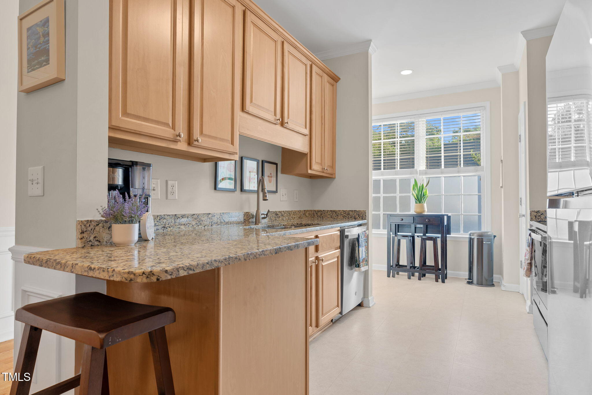 4 Scottish Lane Durham, NC 27707 - Photo 16 of 49 a kitchen with stainless steel appliances granite countertop a sink and dishwasher a stove a dining table and chairs with wooden floor