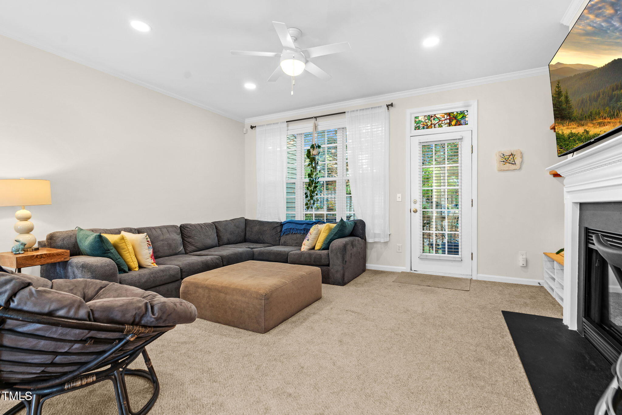 4 Scottish Lane Durham, NC 27707 - Photo 24 of 49 a living room with furniture a flat screen tv and a fireplace