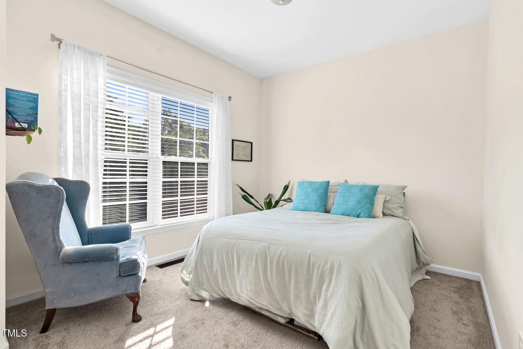 4 Scottish Lane Durham, NC 27707 - Photo 32 of 49 a bedroom with a bed and a couch next to a window