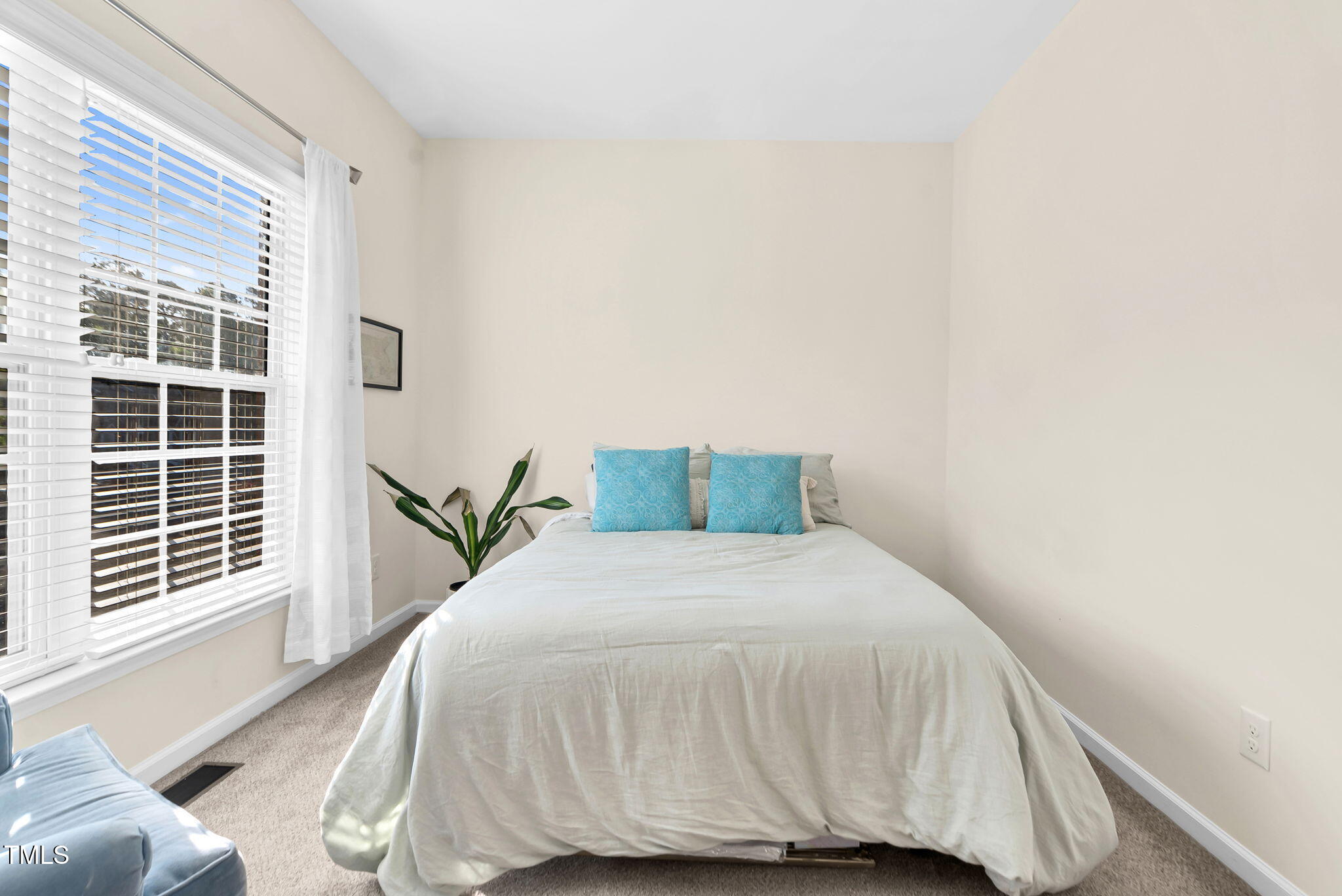 4 Scottish Lane Durham, NC 27707 - Photo 33 of 49 a bed sitting in a bedroom next to a window