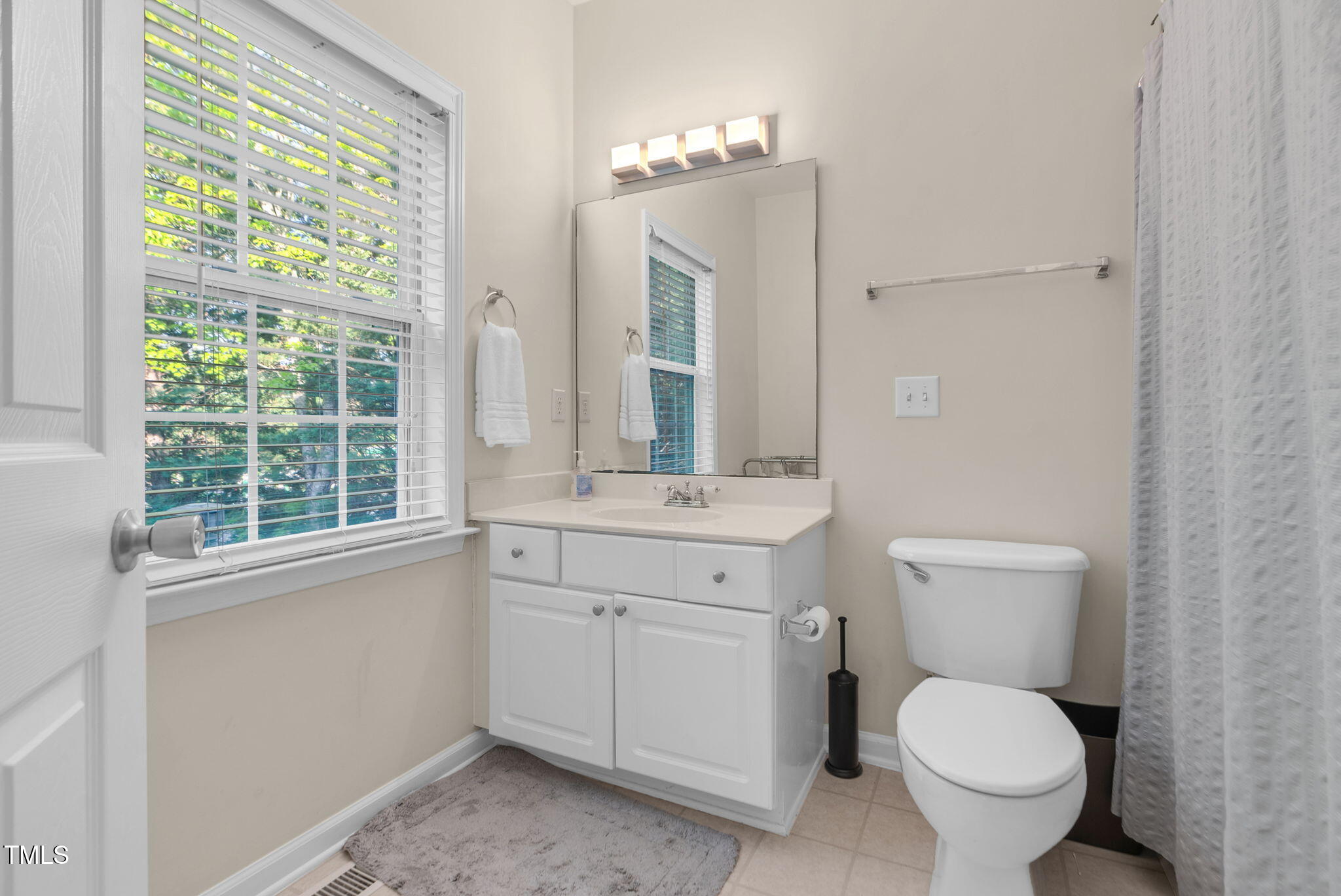 4 Scottish Lane Durham, NC 27707 - Photo 41 of 49 a bathroom with a toilet sink and mirror
