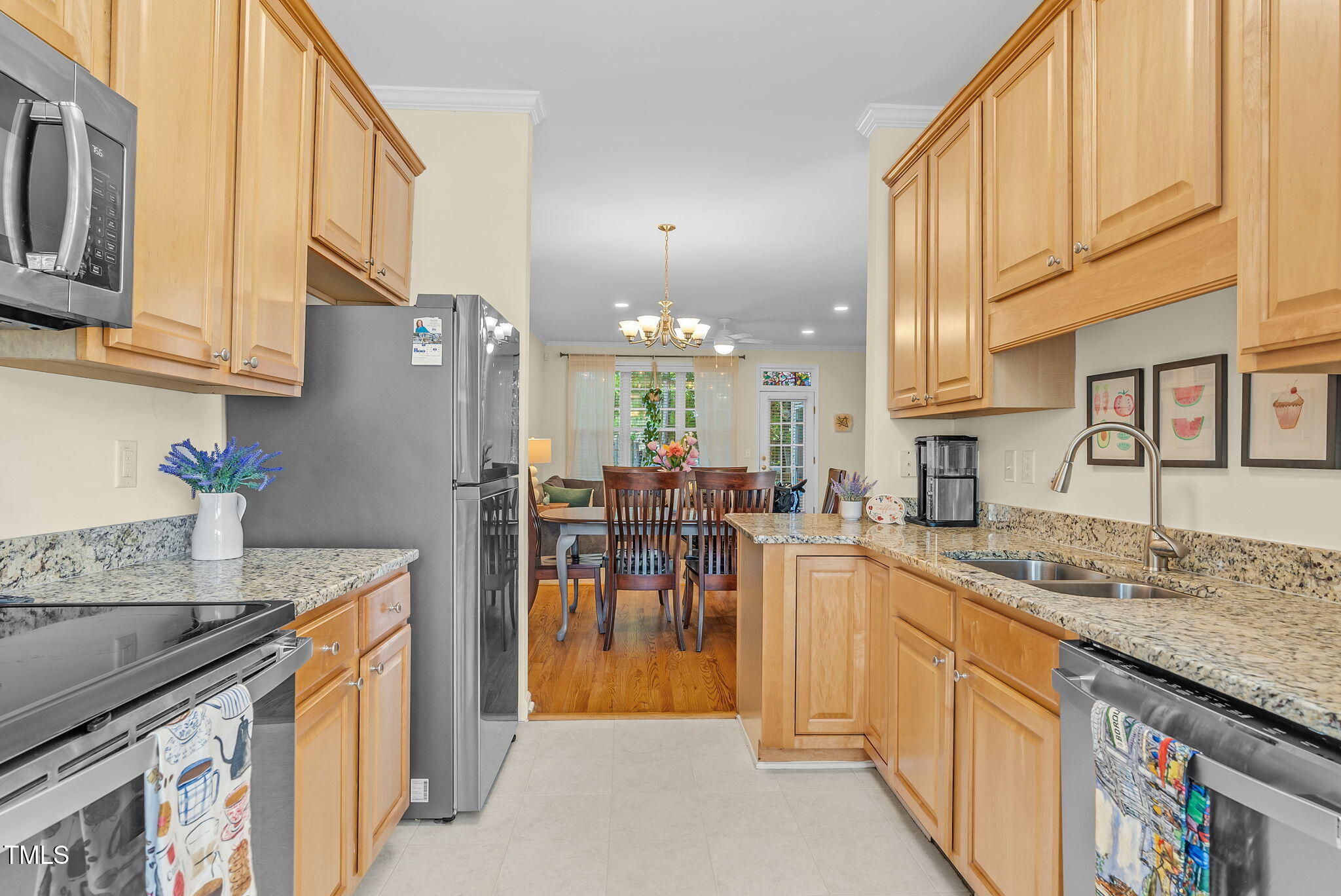 4 Scottish Lane Durham, NC 27707 - Photo 9 of 49 a kitchen with stainless steel appliances granite countertop a sink a stove and a refrigerator