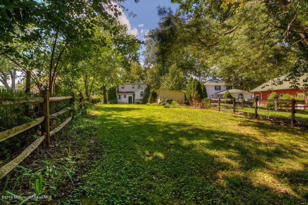 125 Colts Neck Road Farmingdale, NJ 07727 - Photo 16 of 17 a view of yard with swimming pool and trees