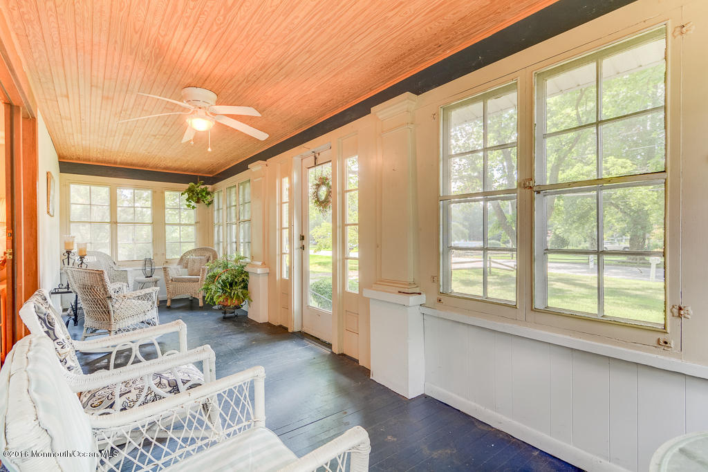 125 Colts Neck Road Farmingdale, NJ 07727 - Photo 2 of 17 a living room with furniture and floor to ceiling windows