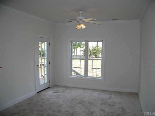 4225 Standing Rock Way Raleigh, NC 27604 - Photo 5 of 8 an empty room with chandelier fan and windows