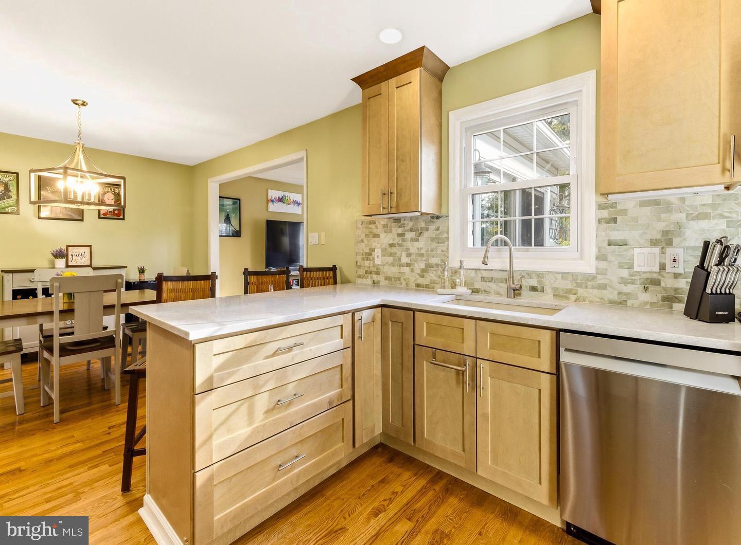 656 East Greenman Road Haddonfield, NJ 08033 - Photo 5 of 22 a kitchen with sink cabinets and wooden floor