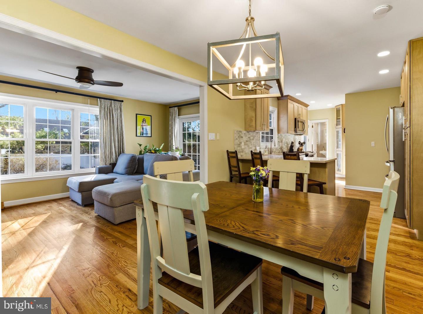 656 East Greenman Road Haddonfield, NJ 08033 - Photo 8 of 22 a dining room with furniture a chandelier and wooden floor