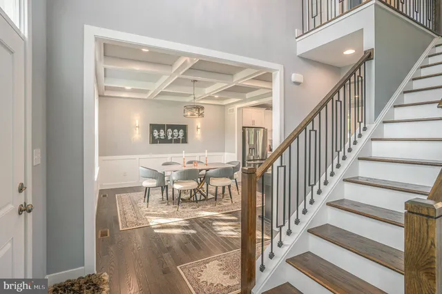 a view of entryway and hall with wooden floor