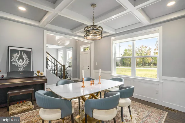 a dining room with furniture a chandelier and window