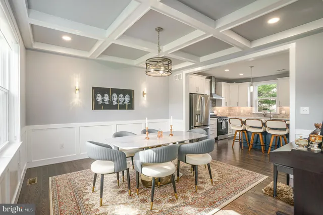 a dining room with furniture a chandelier and window