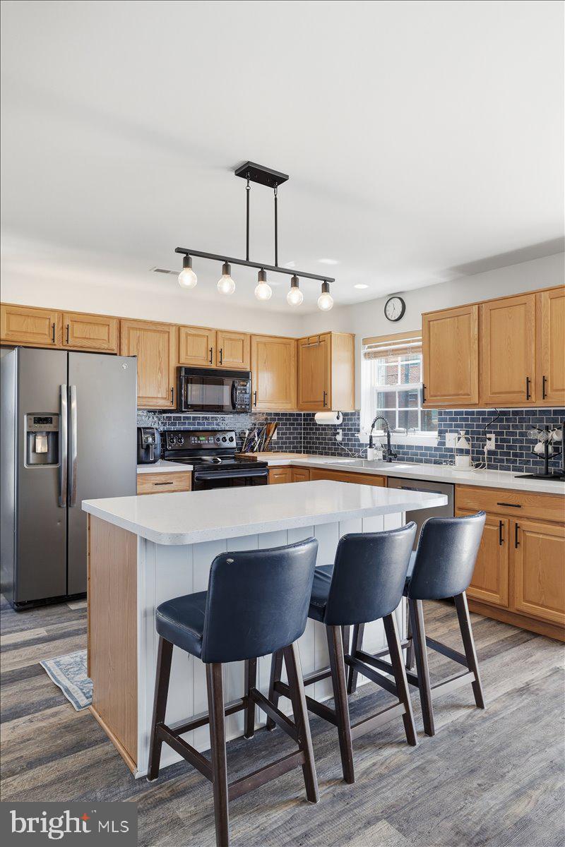 215 Birch Street Walnutport, PA 18088 - Photo 17 of 48 a kitchen with stainless steel appliances a table and chairs in it