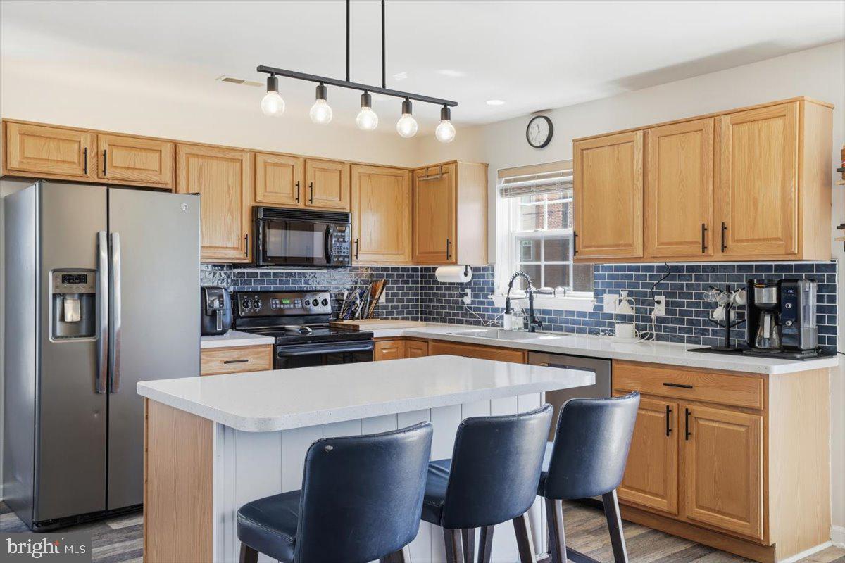 215 Birch Street Walnutport, PA 18088 - Photo 20 of 48 a kitchen with granite countertop a stove top oven a sink dishwasher a refrigerator with a dining table and chairs