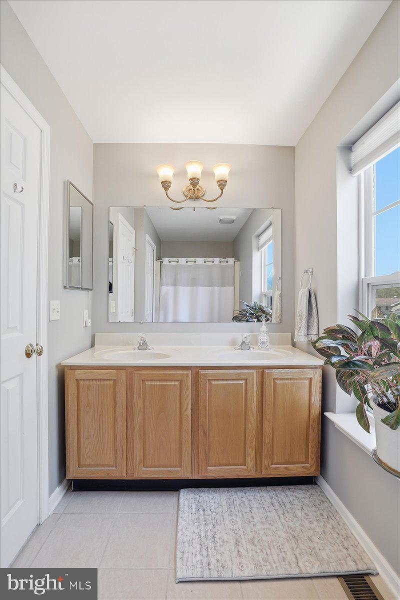 215 Birch Street Walnutport, PA 18088 - Photo 31 of 48 a spacious bathroom with a tub double vanity and a mirror