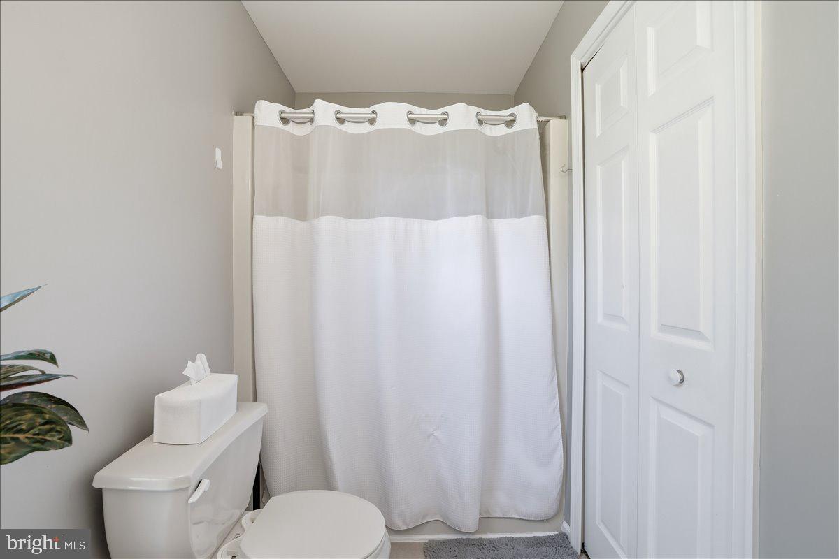 215 Birch Street Walnutport, PA 18088 - Photo 32 of 48 a white toilet sitting next to a shower curtain