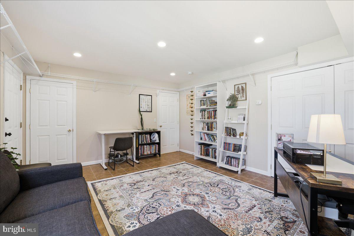 215 Birch Street Walnutport, PA 18088 - Photo 5 of 48 a living room with a couch and a bookshelf with wooden floor