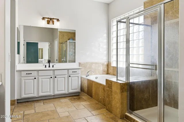 a view of a livingroom with wooden floor and a ceiling fan