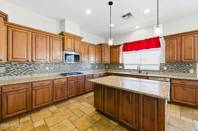a bathroom with a double vanity sink and mirror with bathtub