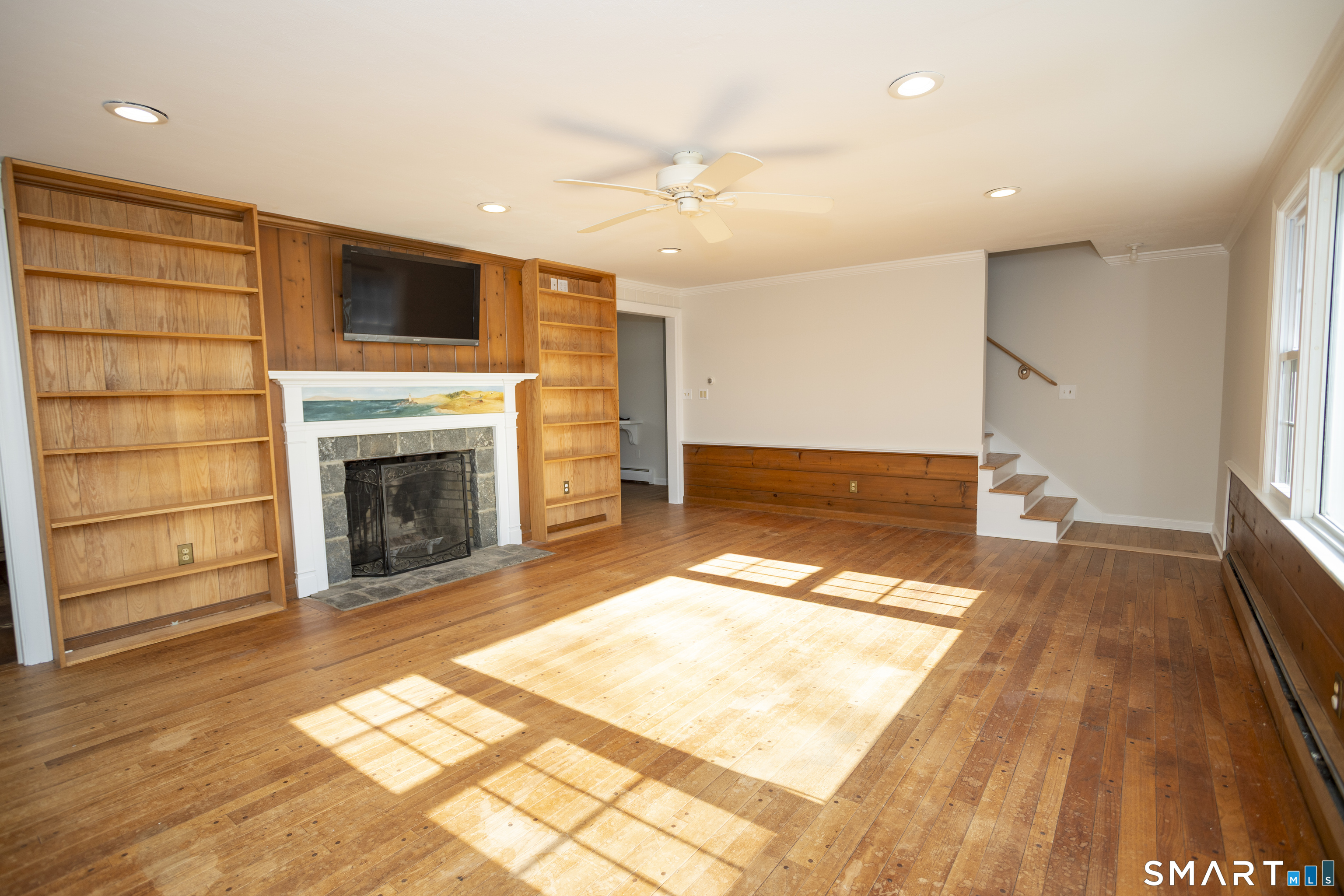 10 Cove Hill Road Essex, CT 06426 - Photo 19 of 38 a view of livingroom with wooden floor and fireplace