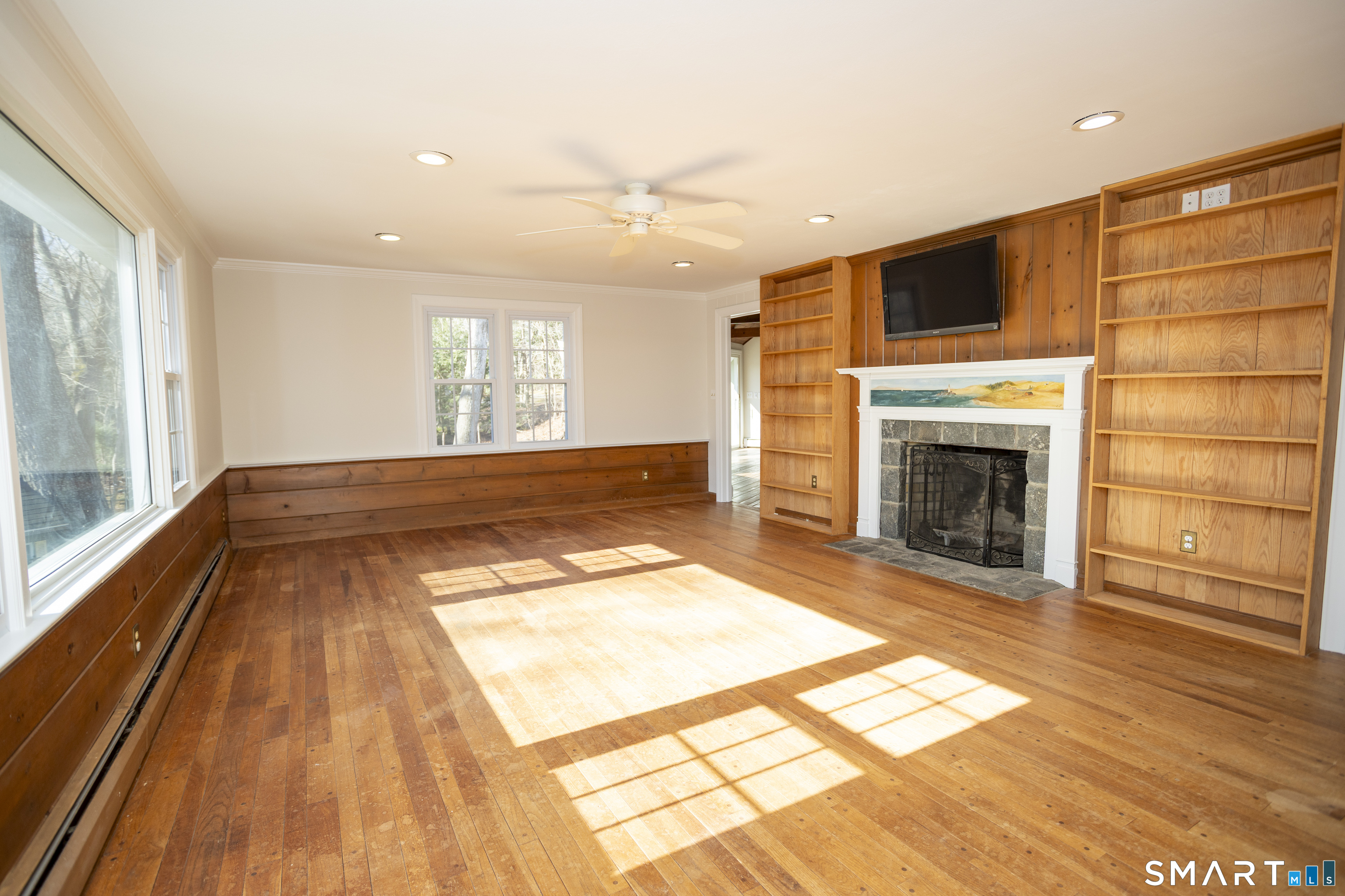 10 Cove Hill Road Essex, CT 06426 - Photo 20 of 38 a view of empty room with wooden floor and fireplace