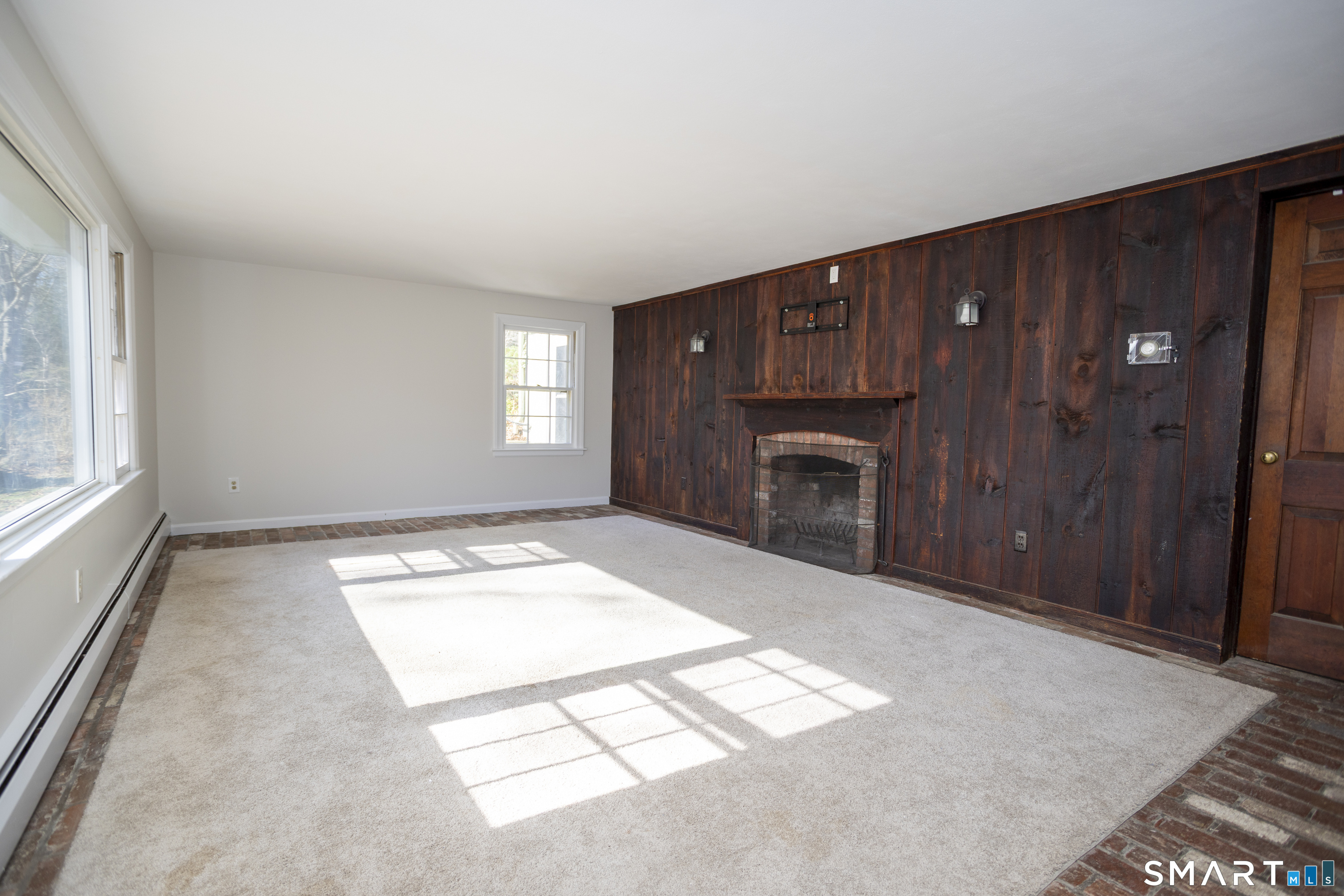 10 Cove Hill Road Essex, CT 06426 - Photo 22 of 38 a view of an empty room with a fireplace and a window