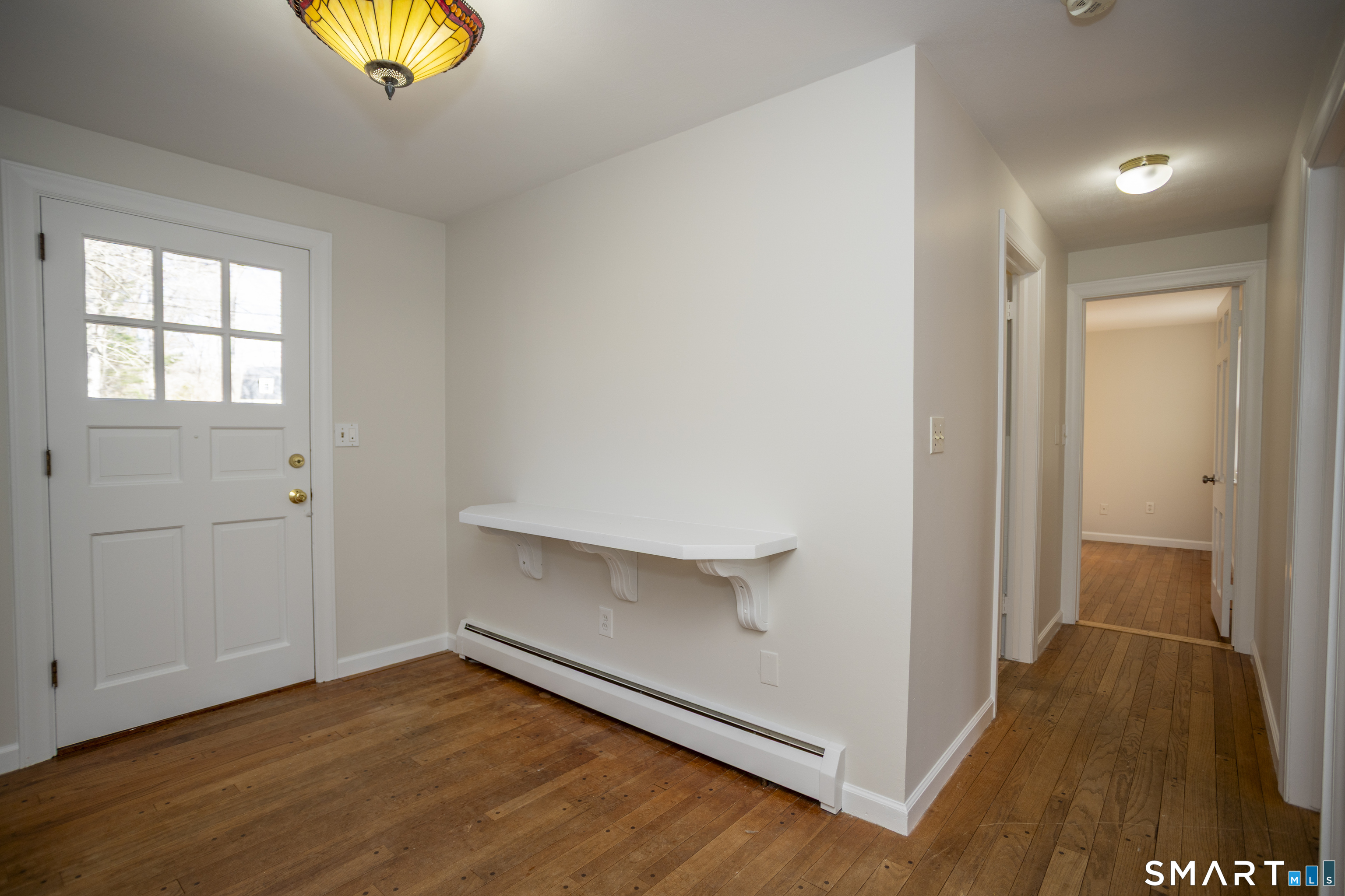 10 Cove Hill Road Essex, CT 06426 - Photo 30 of 38 an empty room with wooden floor and natural light