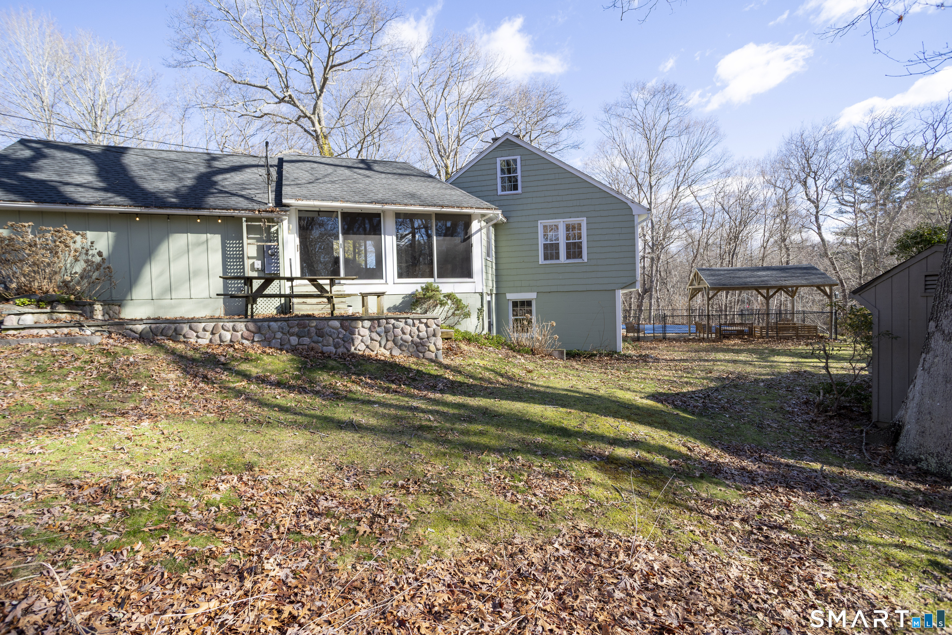 10 Cove Hill Road Essex, CT 06426 - Photo 3 of 38 a view of a house with a yard patio and fire pit