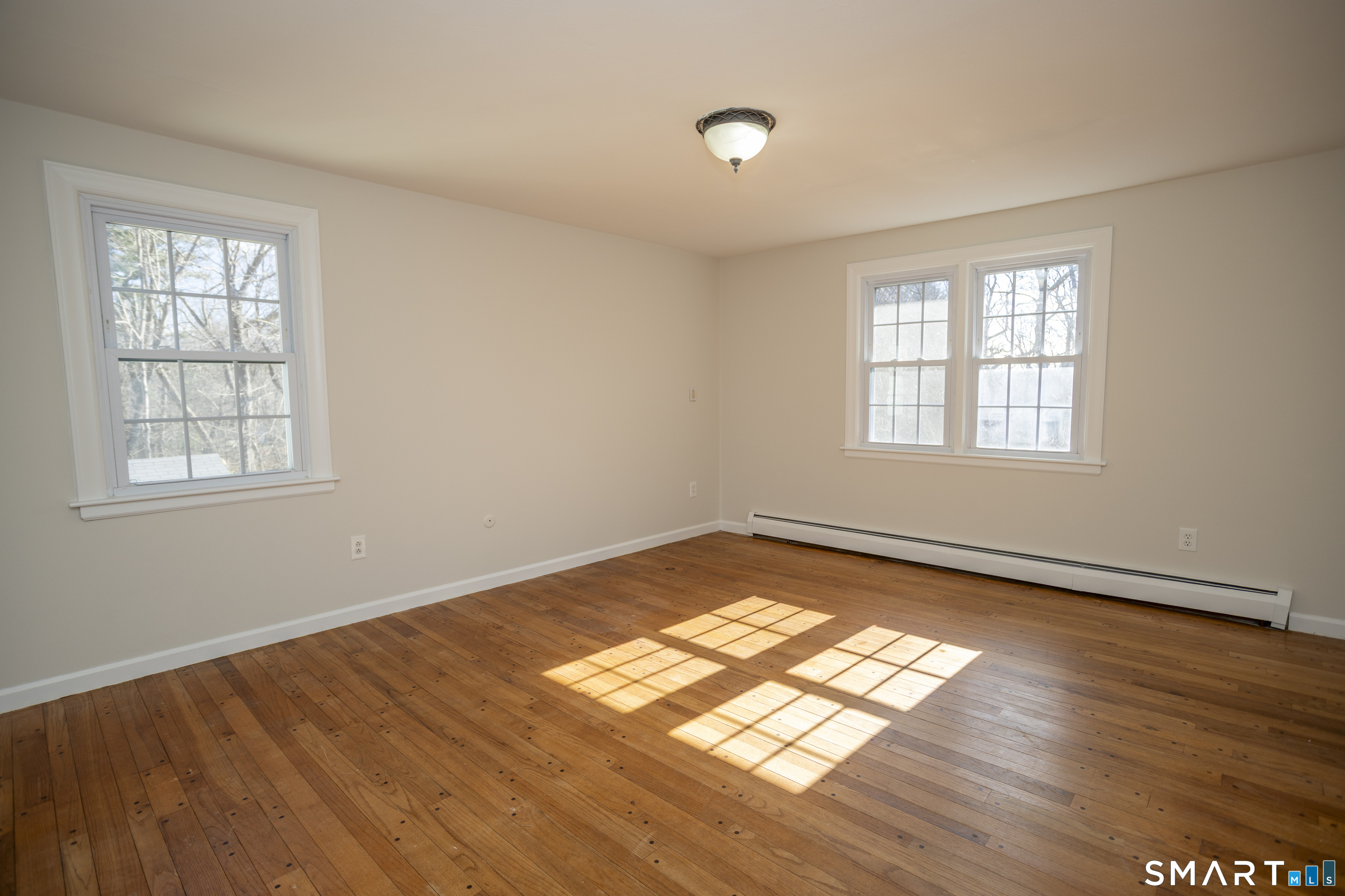 10 Cove Hill Road Essex, CT 06426 - Photo 31 of 38 an empty room with wooden floor and windows