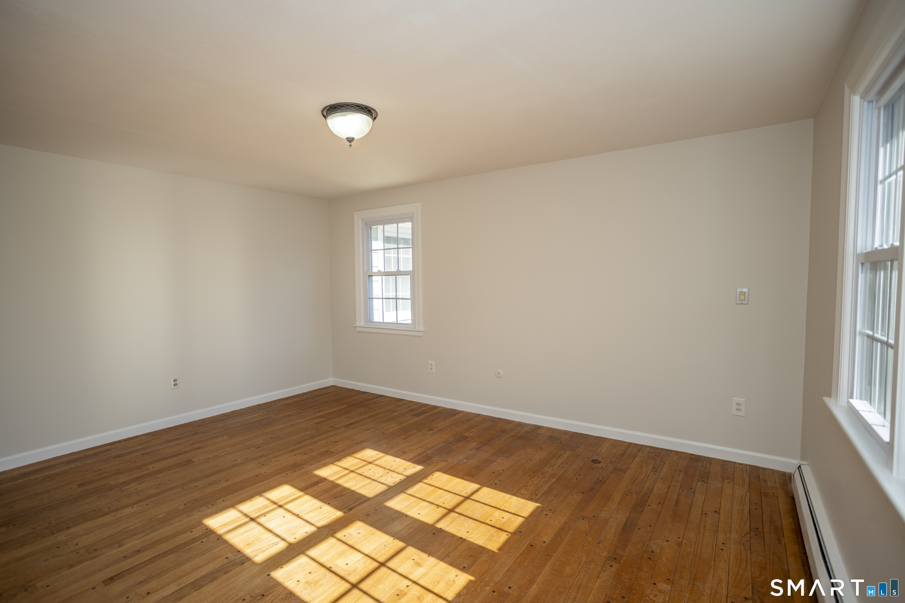 10 Cove Hill Road Essex, CT 06426 - Photo 32 of 38 an empty room with wooden floor and windows