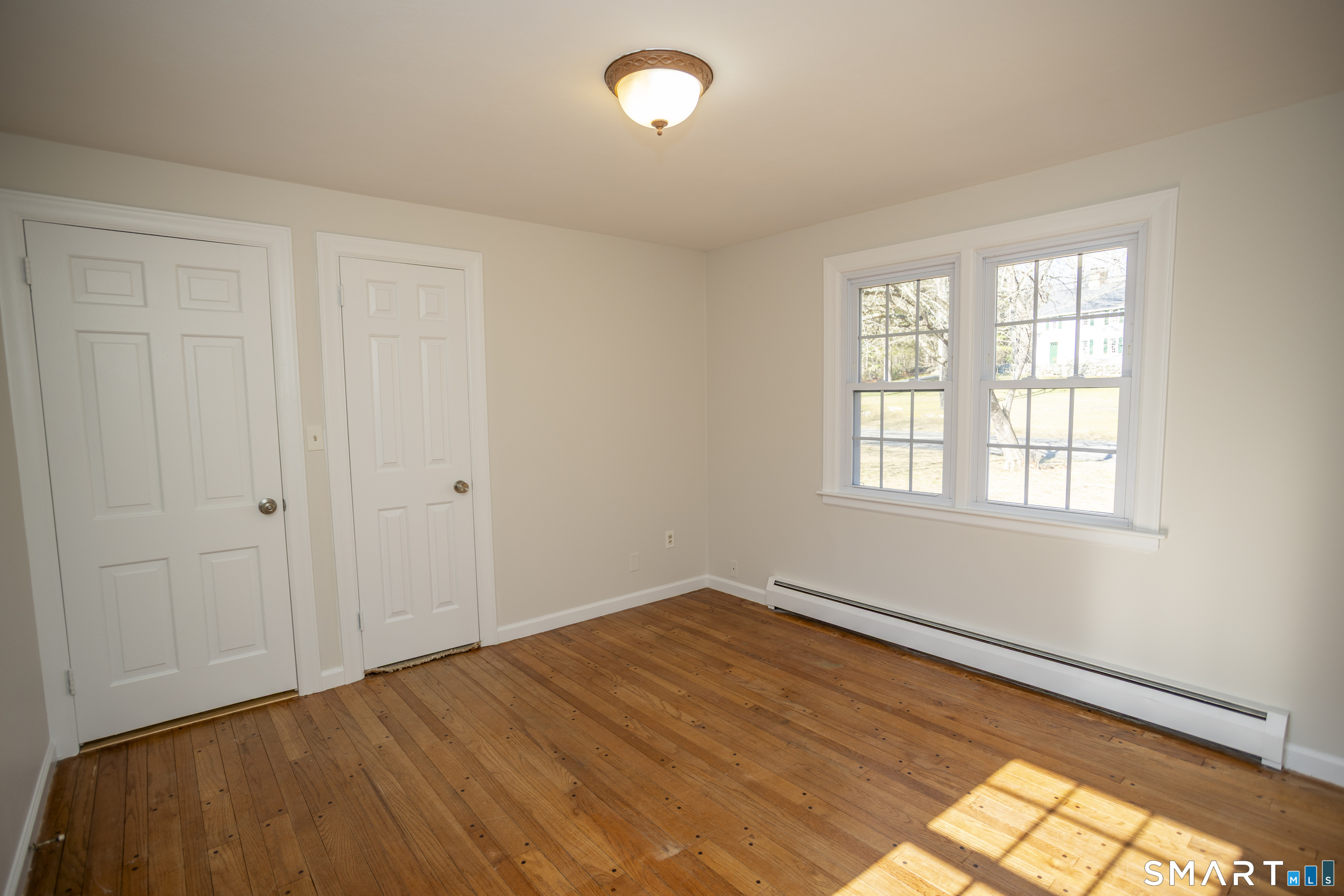 10 Cove Hill Road Essex, CT 06426 - Photo 34 of 38 a view of empty room with wooden floor and fan