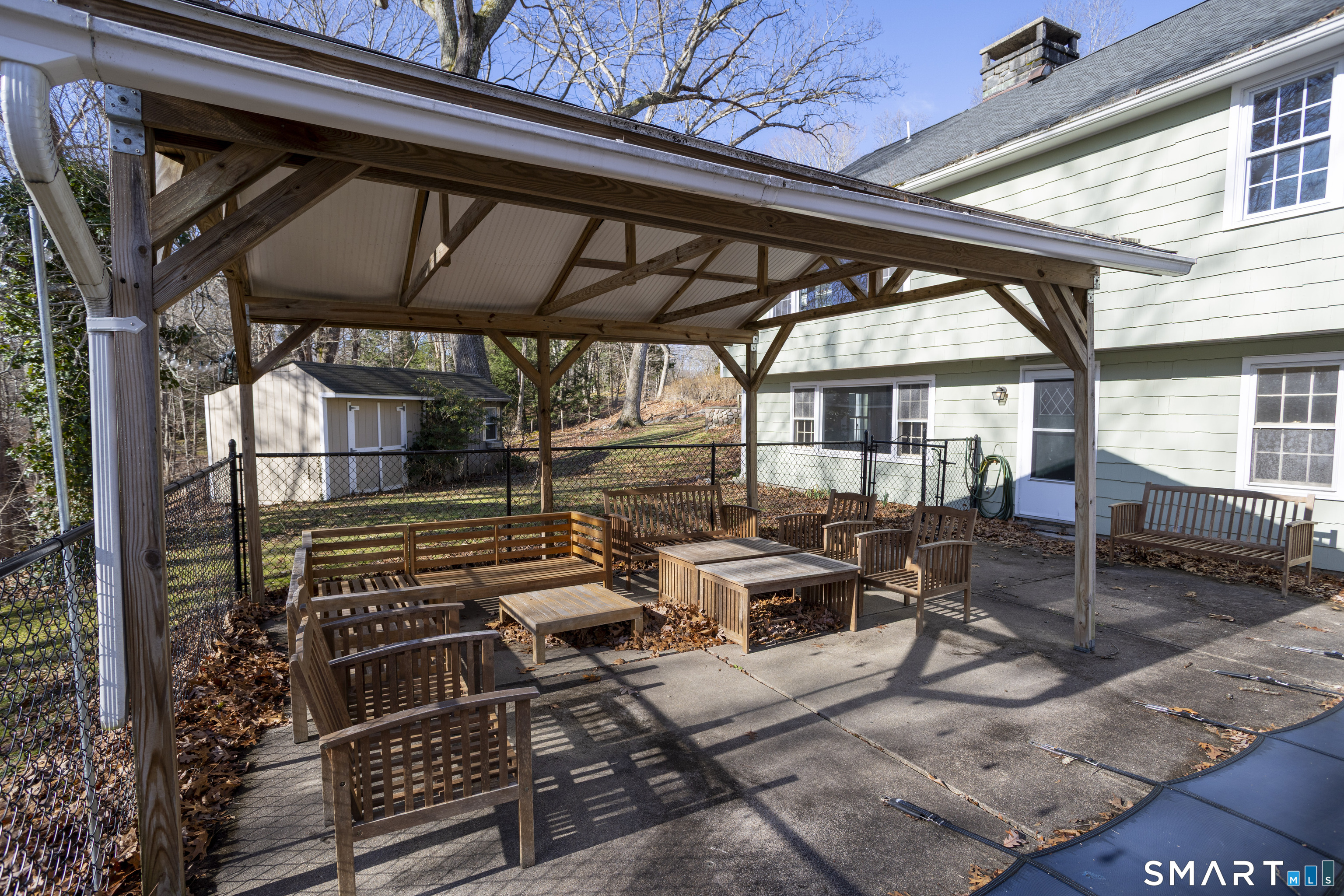 10 Cove Hill Road Essex, CT 06426 - Photo 8 of 38 a backyard of a house with barbeque oven table and chairs
