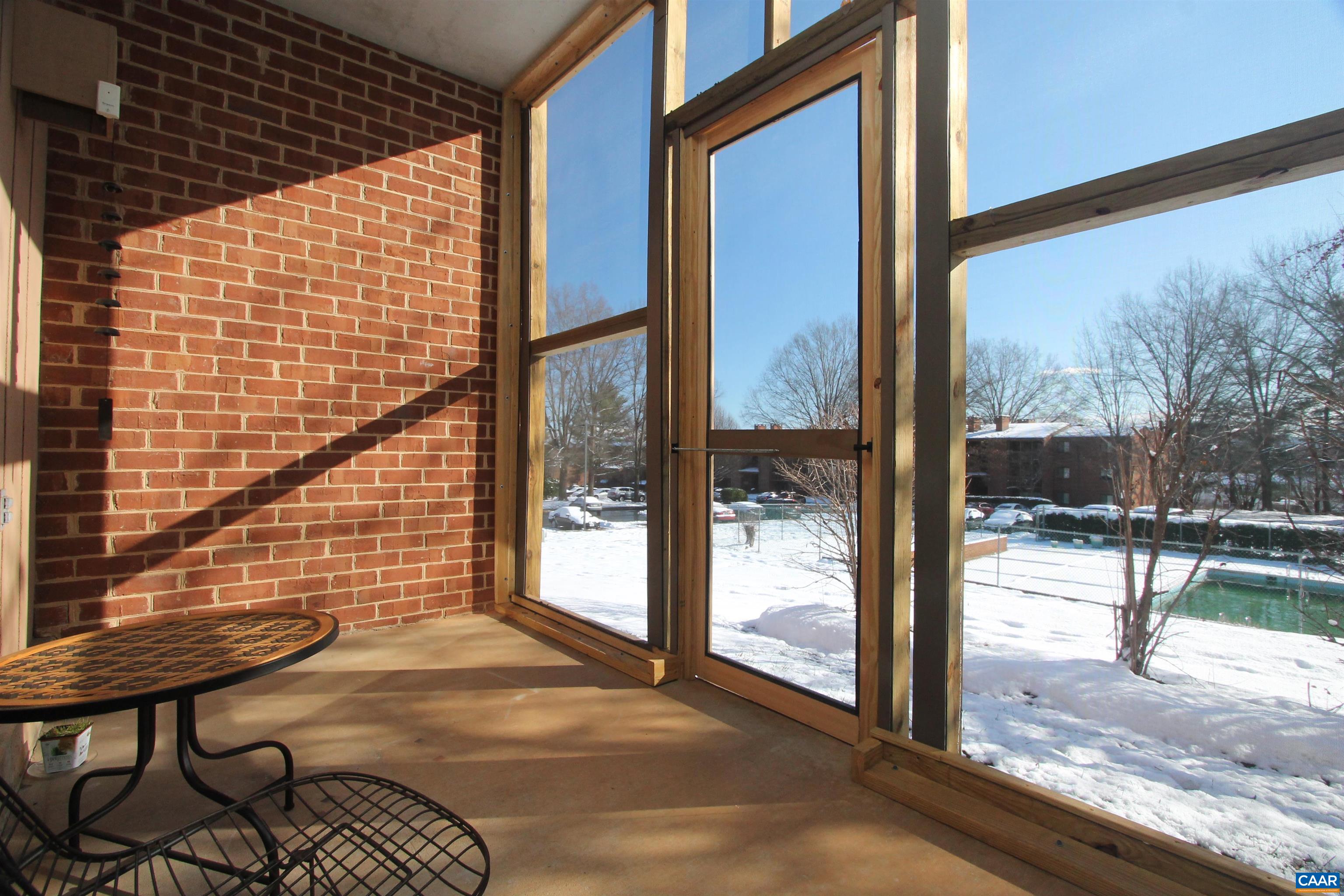 130 Turtle Creek Road, Unit 2 Charlottesville, VA 22901 - Photo 1 of 10 a view of a porch with a table and chairs