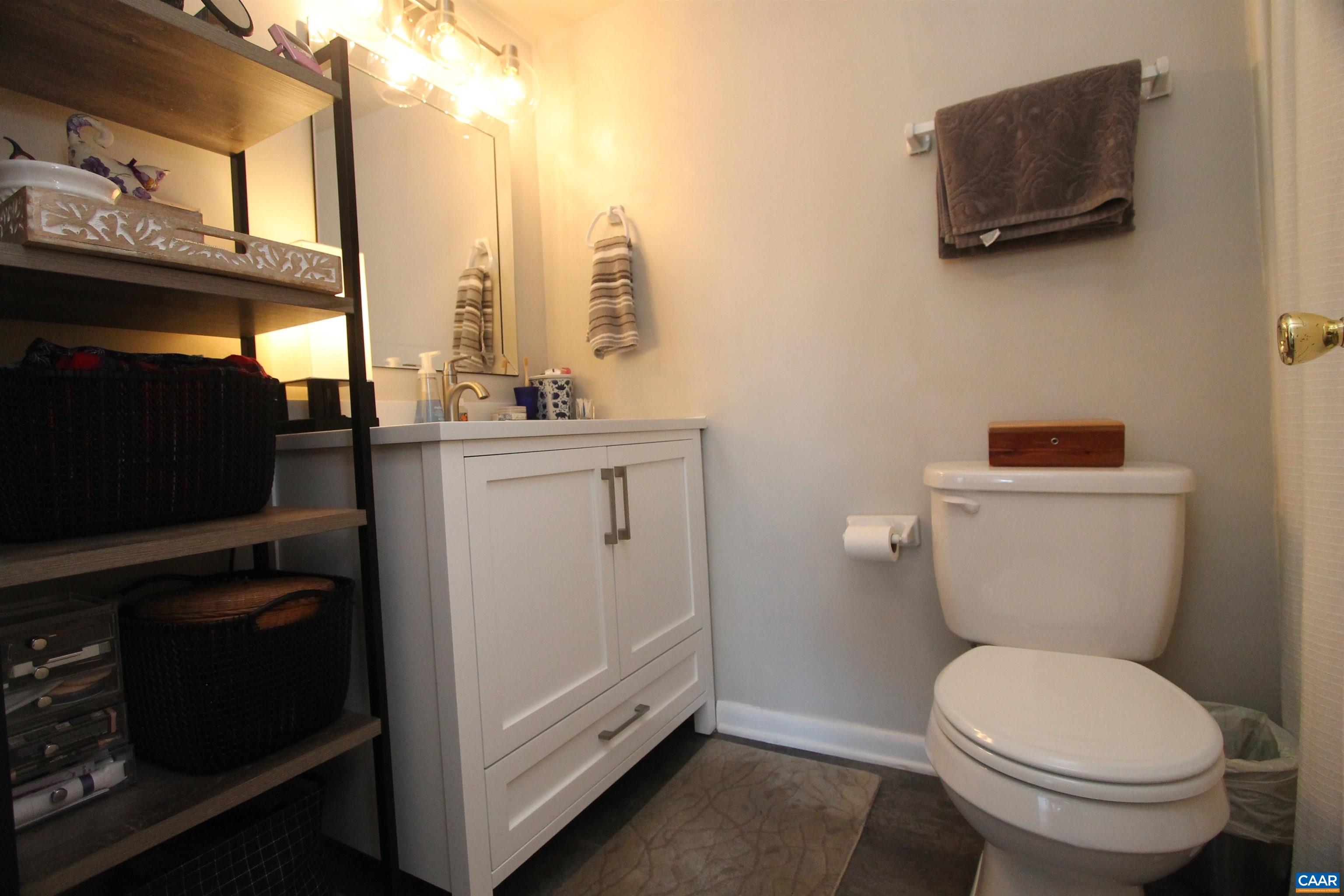 130 Turtle Creek Road, Unit 2 Charlottesville, VA 22901 - Photo 3 of 10 a bathroom with a toilet a sink and a mirror
