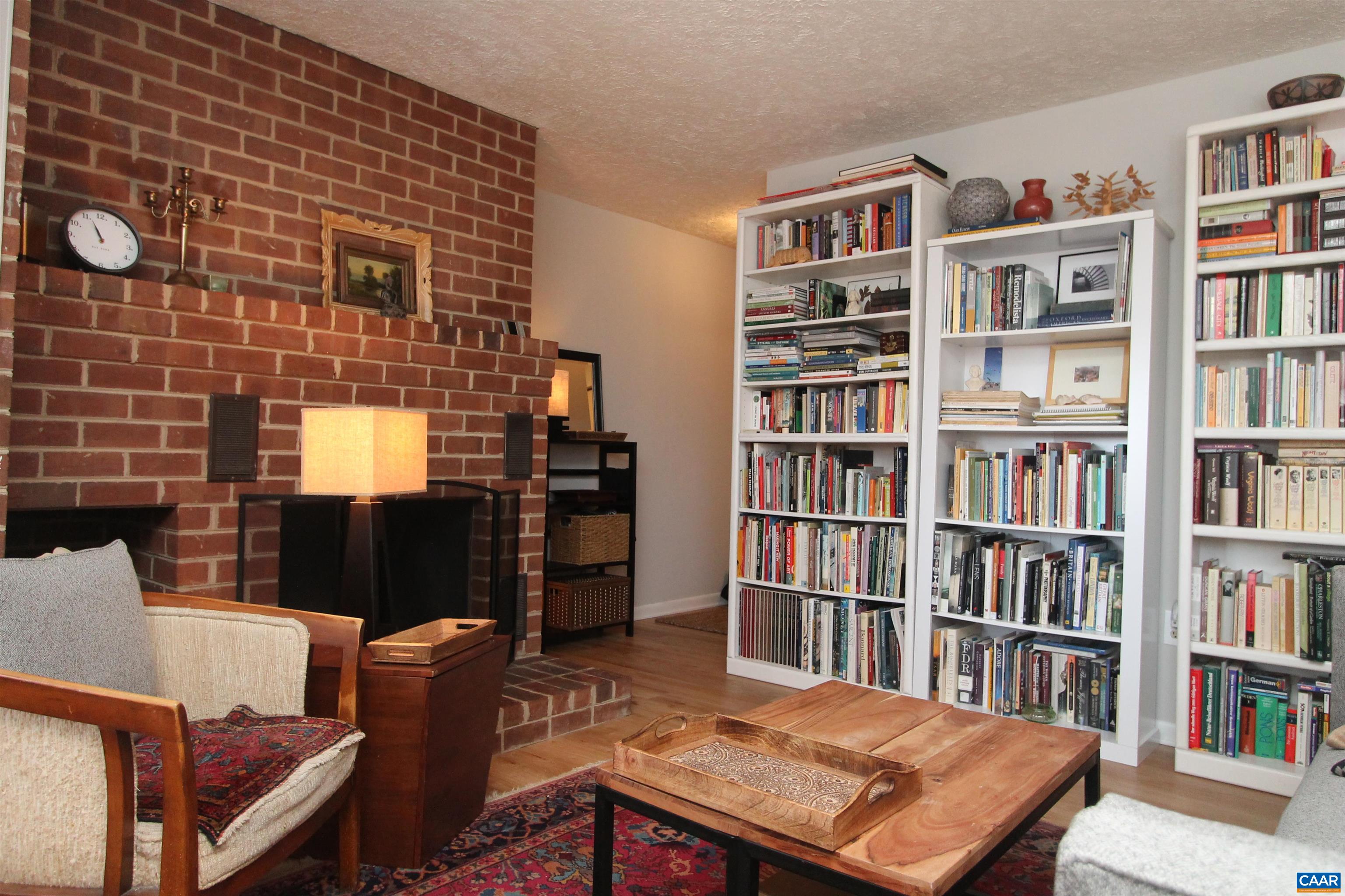 130 Turtle Creek Road, Unit 2 Charlottesville, VA 22901 - Photo 7 of 10 a living room with a bookshelf and a book shelf