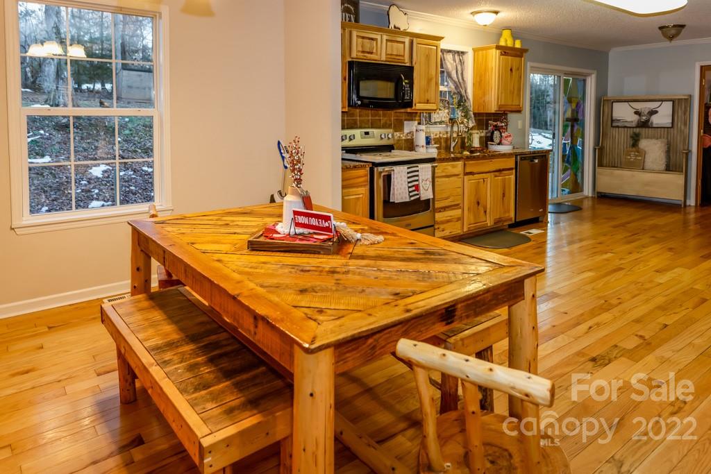 890 Rock Road Rutherfordton, NC 28139 - Photo 14 of 40 a kitchen with stainless steel appliances kitchen island granite countertop a stove top oven a sink a dining table and chairs