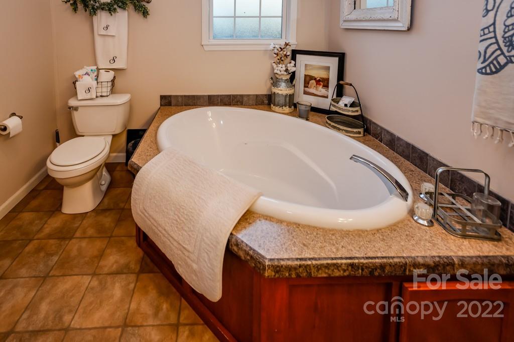 890 Rock Road Rutherfordton, NC 28139 - Photo 19 of 40 a bathroom with a granite countertop sink and a toilet