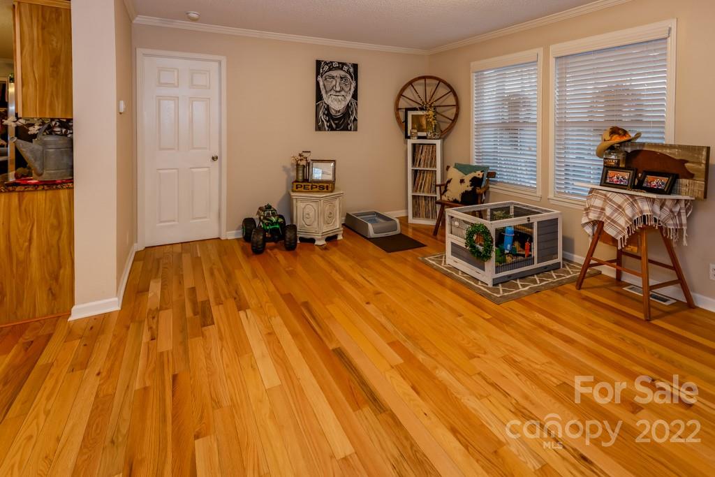890 Rock Road Rutherfordton, NC 28139 - Photo 24 of 40 a bedroom with a bed and wooden floor