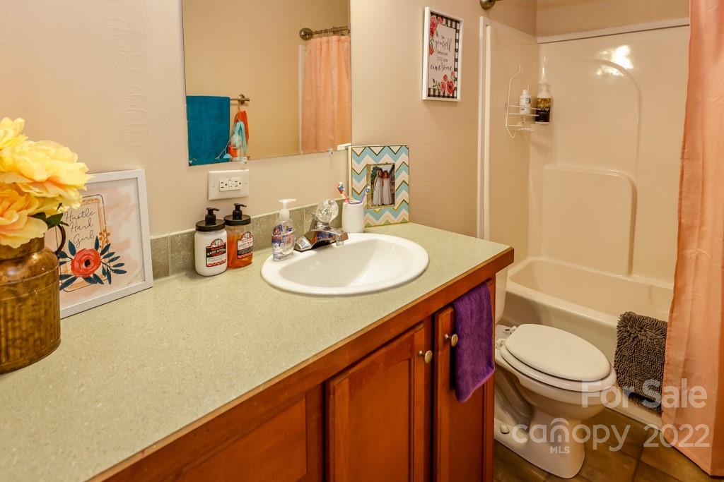 890 Rock Road Rutherfordton, NC 28139 - Photo 25 of 40 a bathroom with a sink a toilet and shower