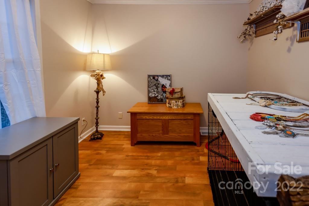890 Rock Road Rutherfordton, NC 28139 - Photo 28 of 40 a bedroom with a bed and a chandelier