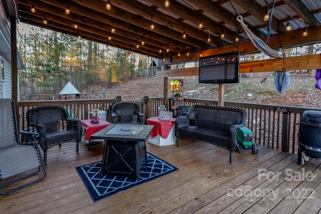890 Rock Road Rutherfordton, NC 28139 - Photo 5 of 40 a living room with furniture a fireplace and next to a window