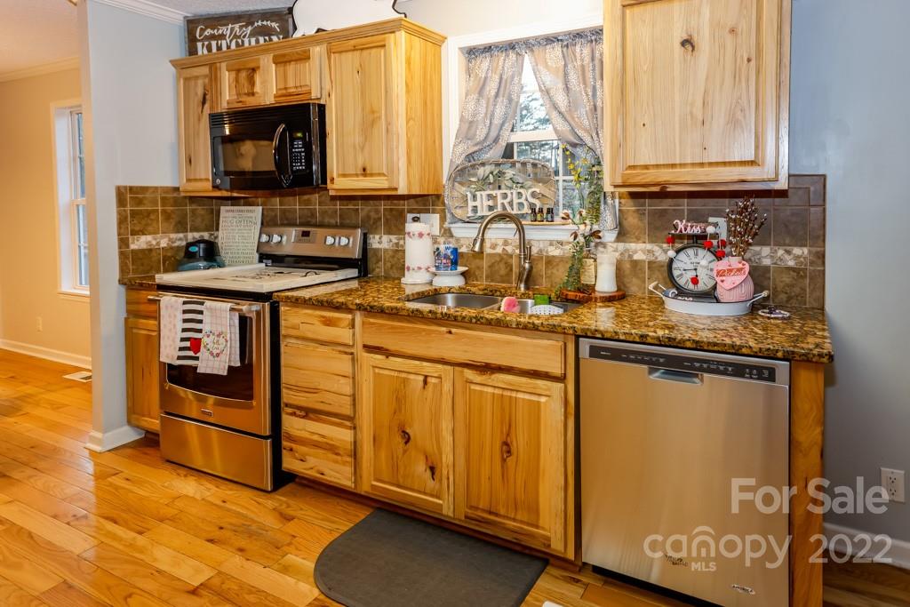890 Rock Road Rutherfordton, NC 28139 - Photo 10 of 40 a kitchen with stainless steel appliances granite countertop a sink stove and cabinets