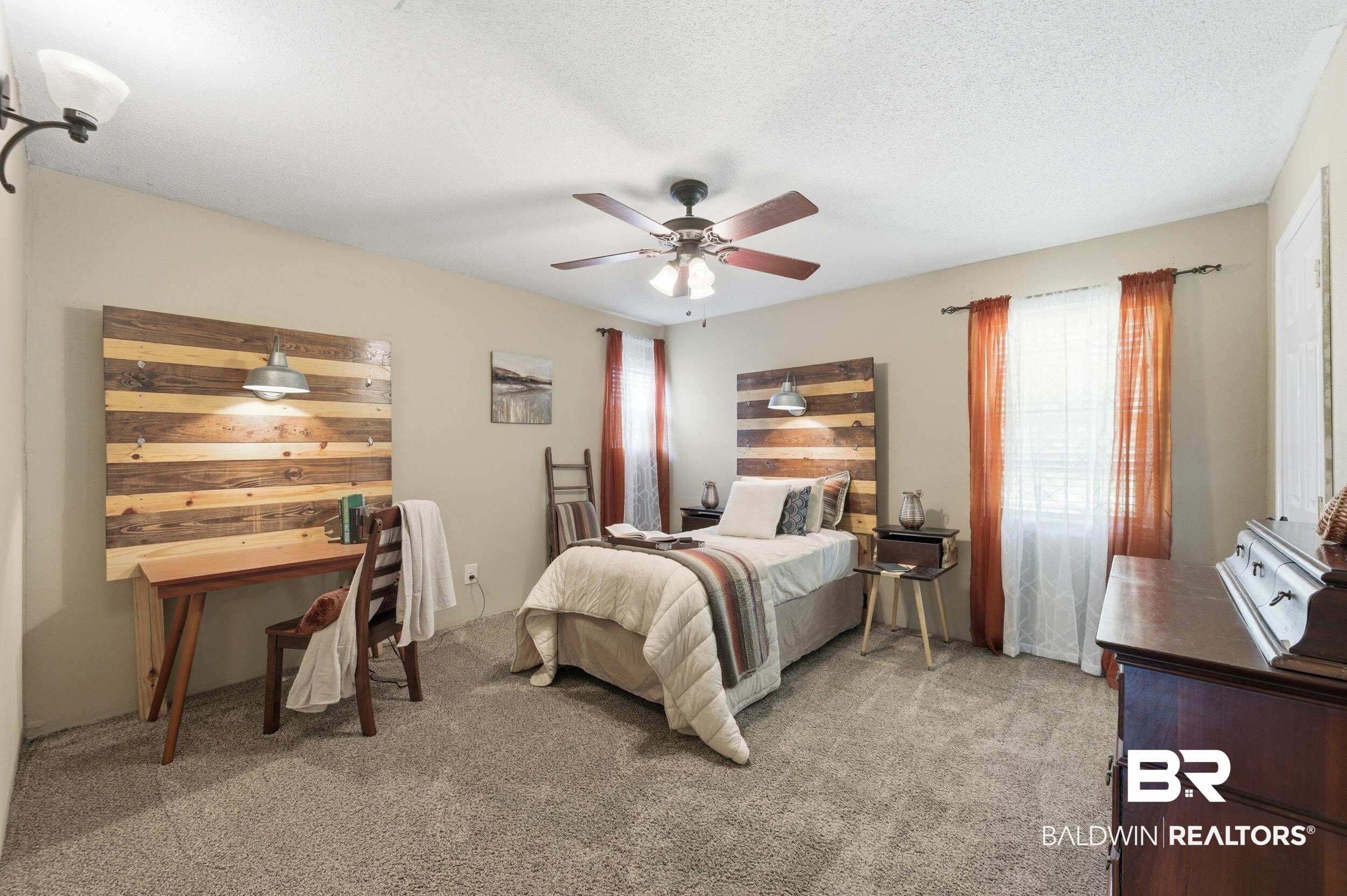51620 Robert White Road Bay Minette, AL 36507 - Photo 58 of 81 Carpeted bedroom featuring a ceiling fan with integrated lighting, a permanent wood-finish accent wall with a built-in industrial-style wall sconce, and a window with blinds