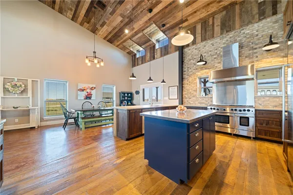 a kitchen with stainless steel appliances granite countertop a sink and wooden cabinets