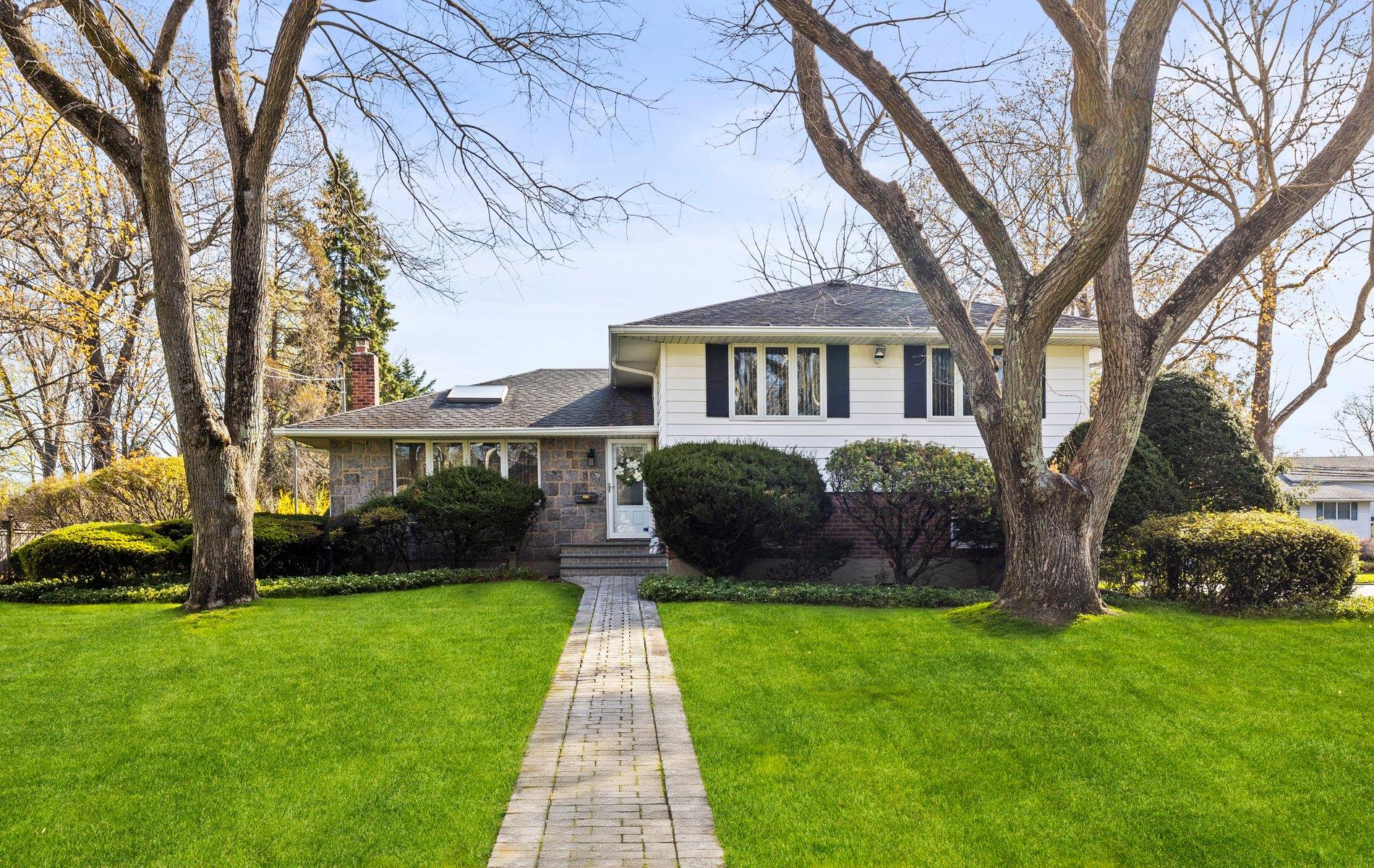 a front view of a house with garden