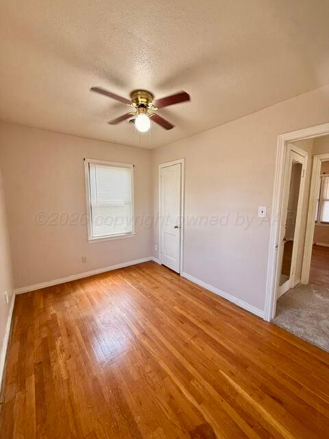 4623 Crockett Street Amarillo, TX 79110 - Photo 8 of 9 a view of empty room with wooden floor and fan