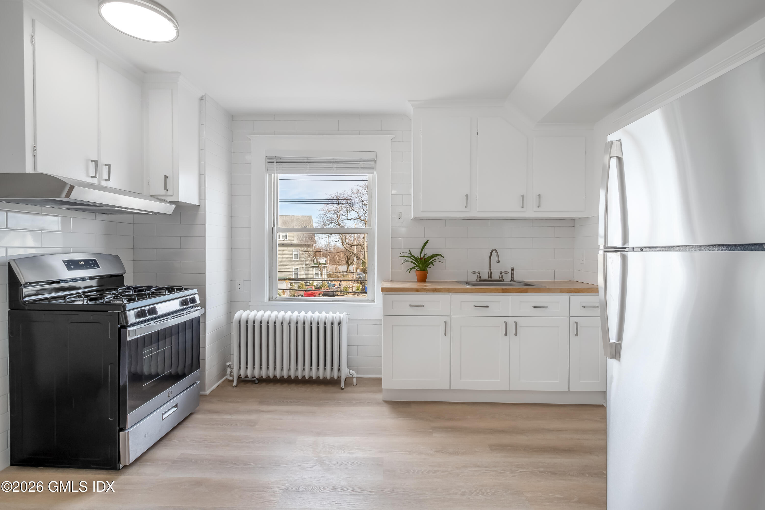 140 Hamilton Avenue, Unit 3 Greenwich, CT 06830 - Photo 2 of 11 a kitchen with granite countertop white cabinets and white appliances